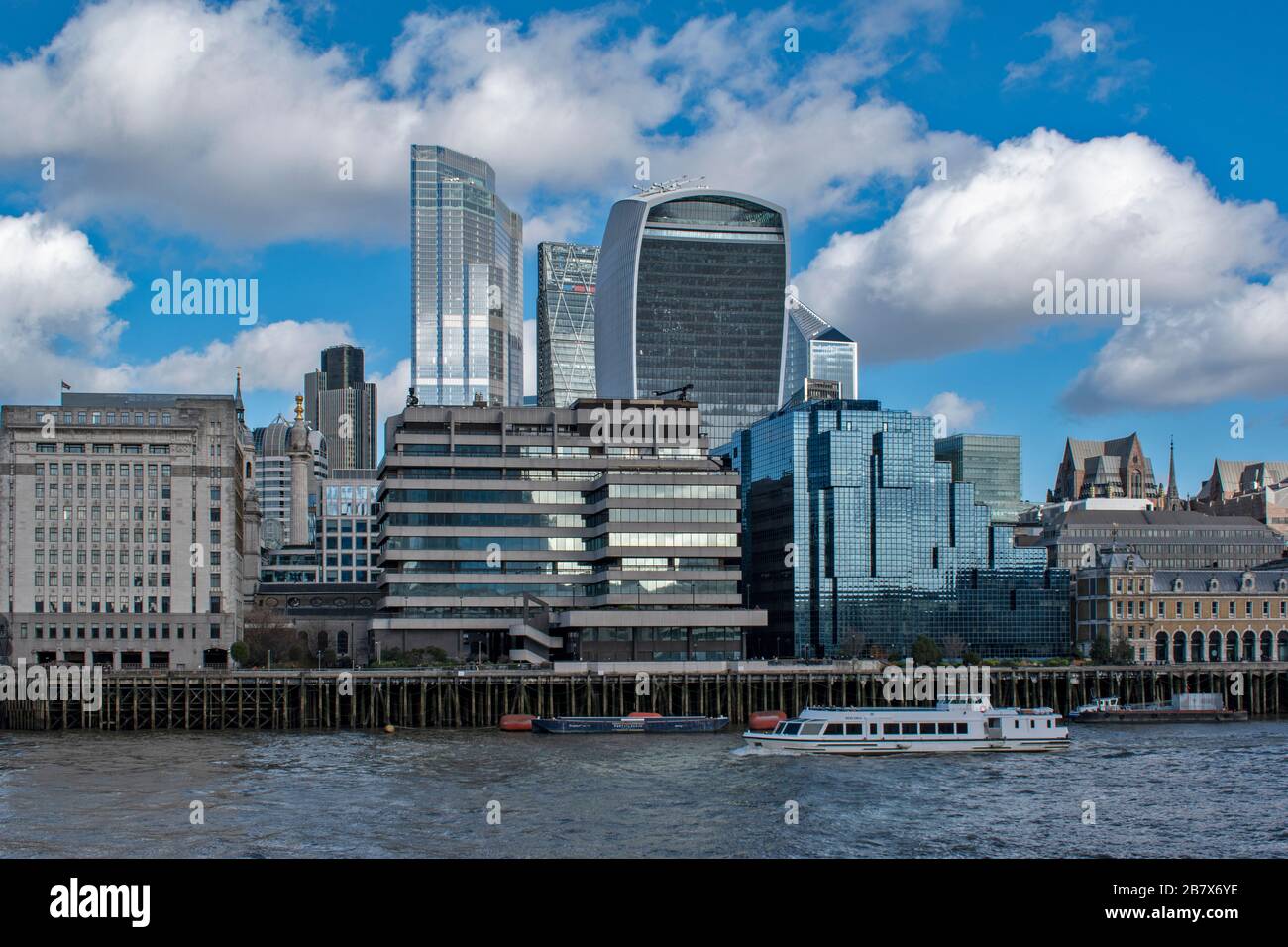 LONDON VIEW OVER THE RIVER THAMES TO BUILDINGS ON LOWER THAMES STREET AND THE WALKIE TALKIE AND CHEESGRATER SKYSCRAPERS Stock Photo
