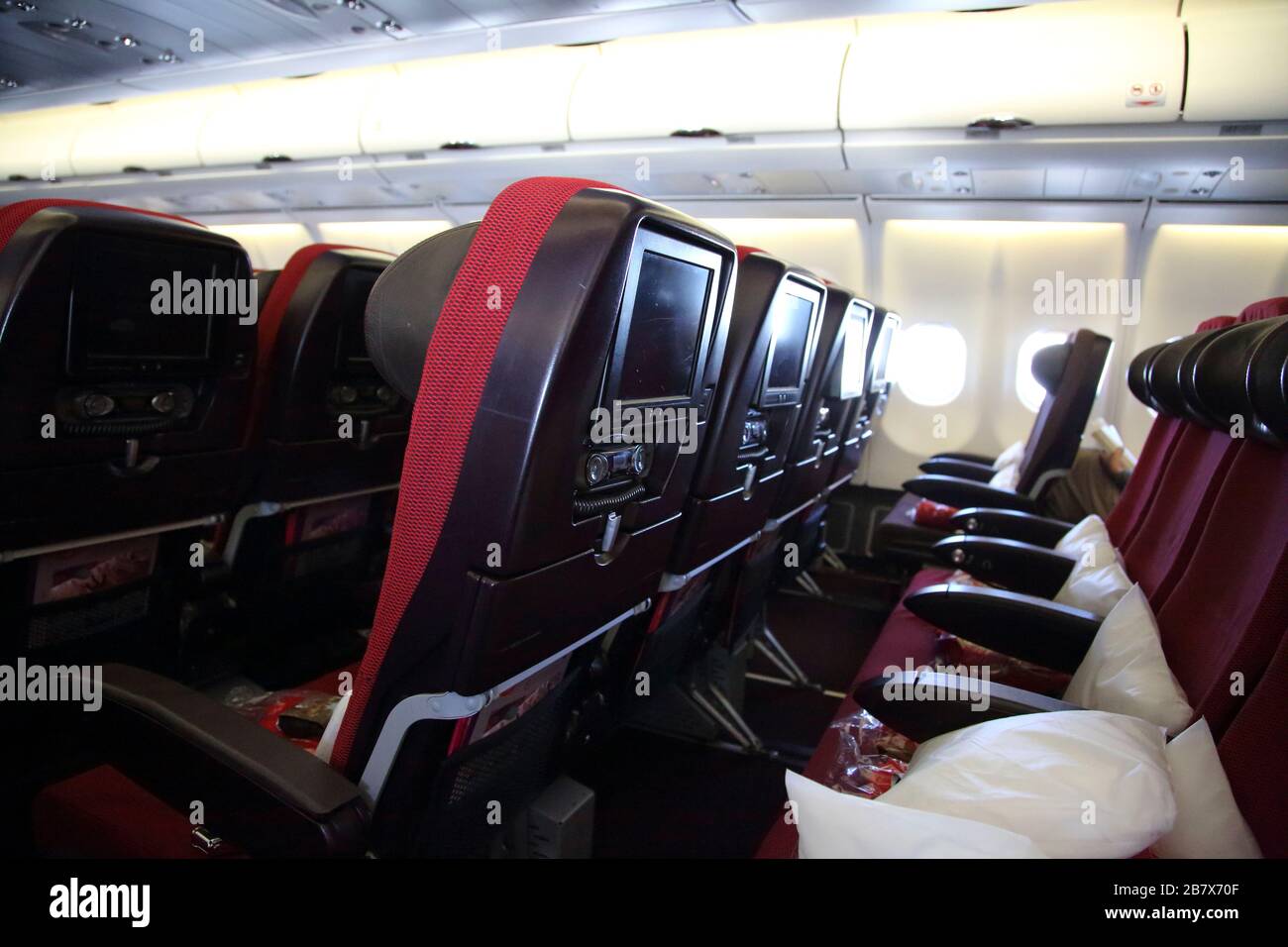 Interior of Aeroplane Boeing 747-400 (744) Showing Television Sets in the Head Rest of the Seats Stock Photo