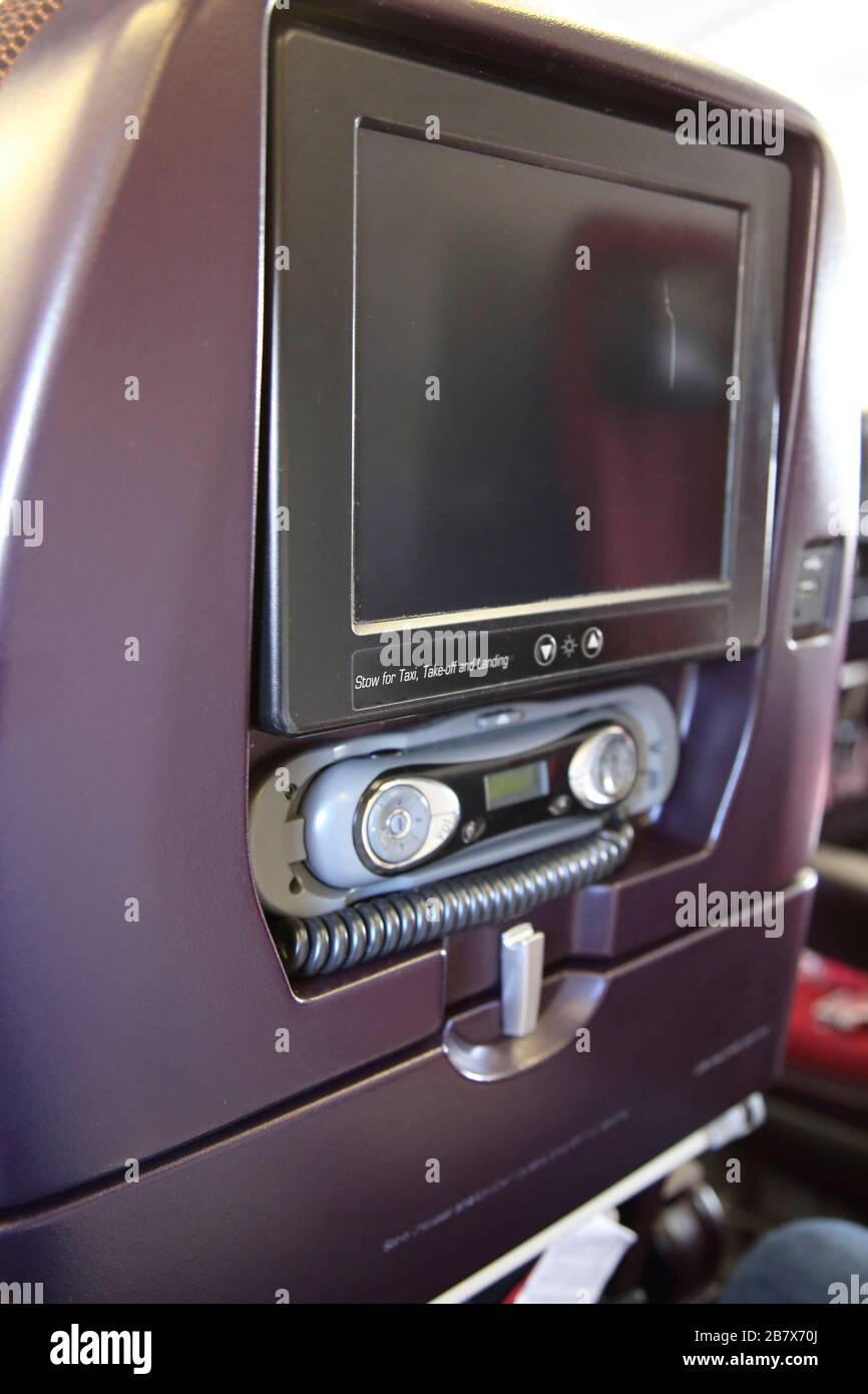 Interior of Aeroplane Boeing 747-400 (744) Showing Television Set in the Head Rest of Seat Stock Photo