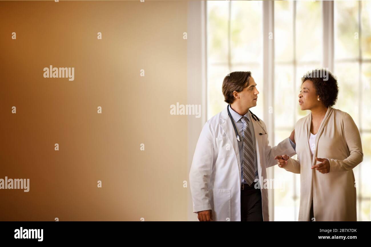 Doctor talking to a patient in a hospital room Stock Photo - Alamy