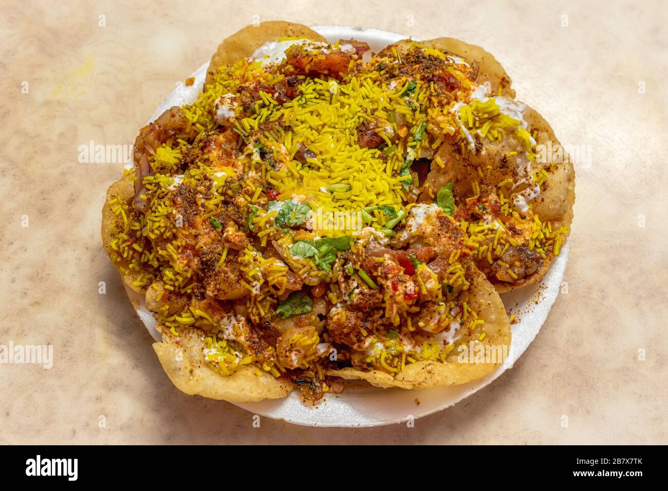 Sev Batata Puri OR Papdi chat is a popular Calcutta street food, a type of chaat, crispy, tangy, moderately healthy (Selective focus) Stock Photo