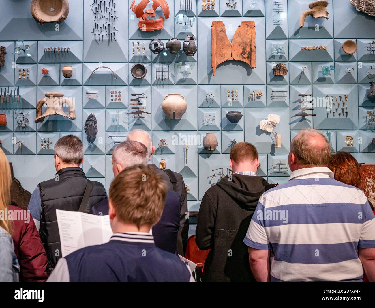 People looking at Roman artefacts at the London Mithraeum Museum Stock Photo