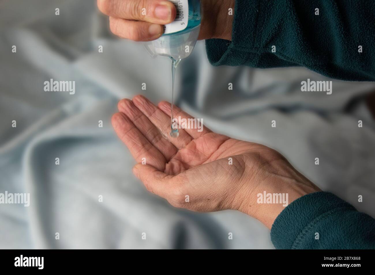 Using hand sanitiser Stock Photo Alamy