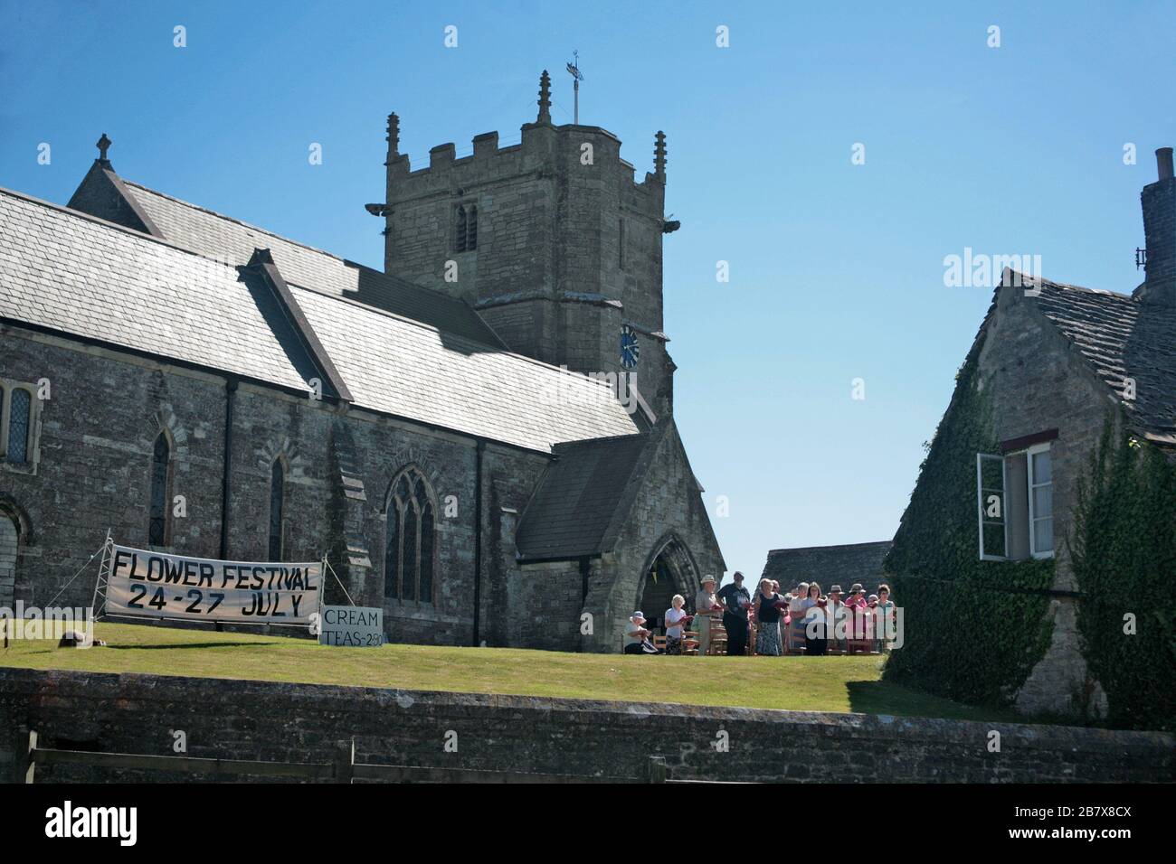 An outdoor service at the Church of St. Edward King and Martyr from East Street, Corfe Castle, Isle of Purbeck, Dorset, England, UK Stock Photo