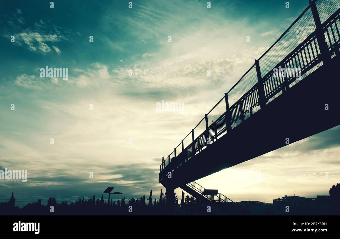 the silhouette of a pedestrian bridge crossing the road Stock Photo - Alamy