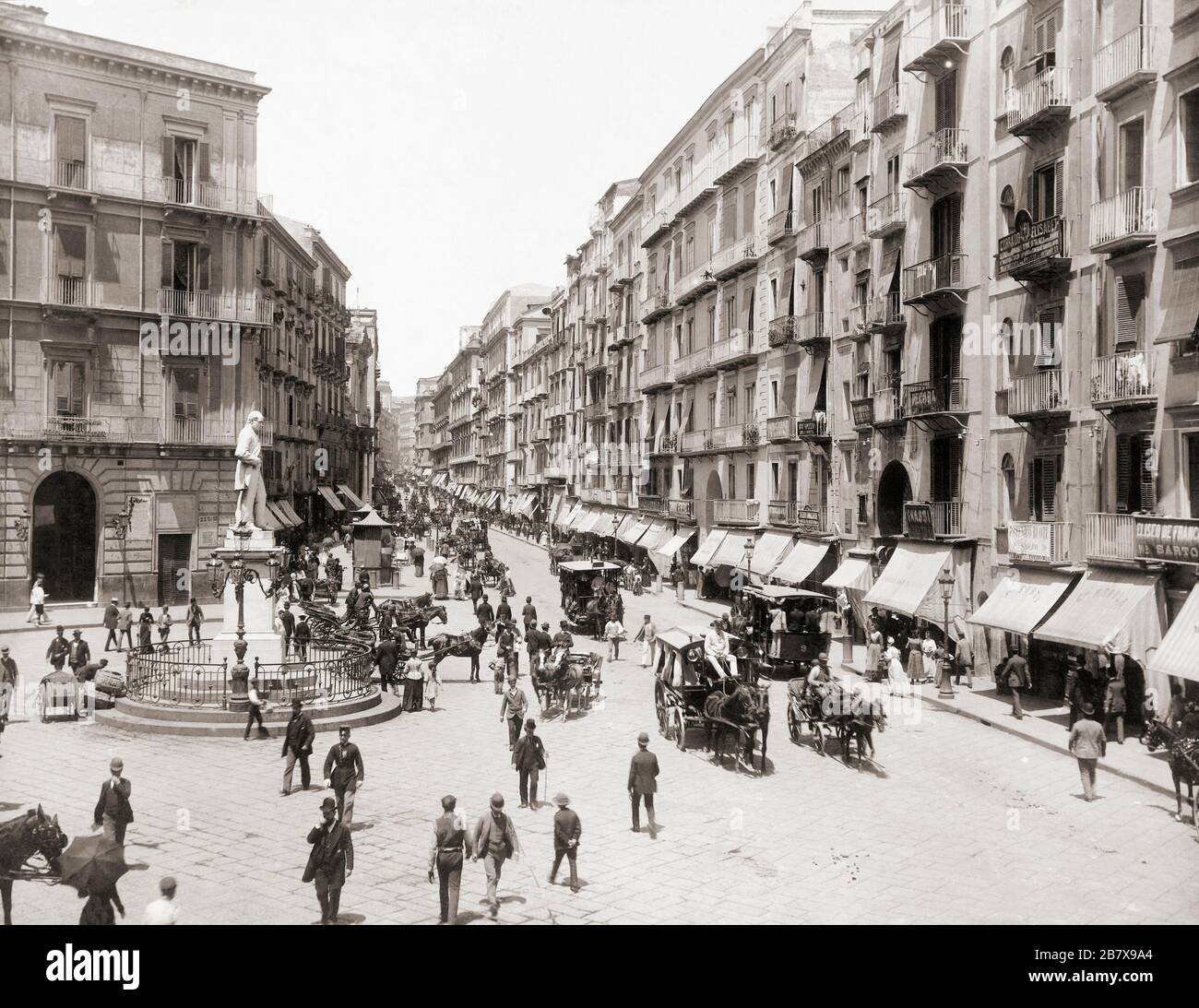The Via Roma in Naples, Italy circa 1895.   The street is now called Via Toledo.  The statue on left is of Italian poet Carlo Poerio, 1804 - 1867.  After a work by German photographer Giorgio Sommer, 1834 - 1914. Stock Photo