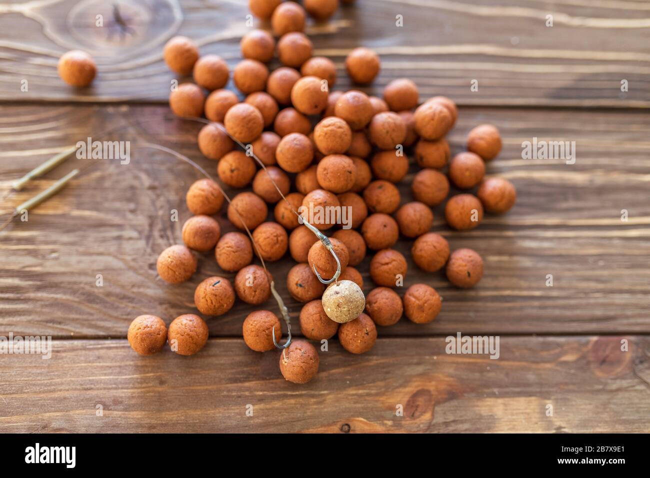 Carp fishing. Different of carp boilies and accessories for carp fishing  isolated on wooden background Stock Photo - Alamy