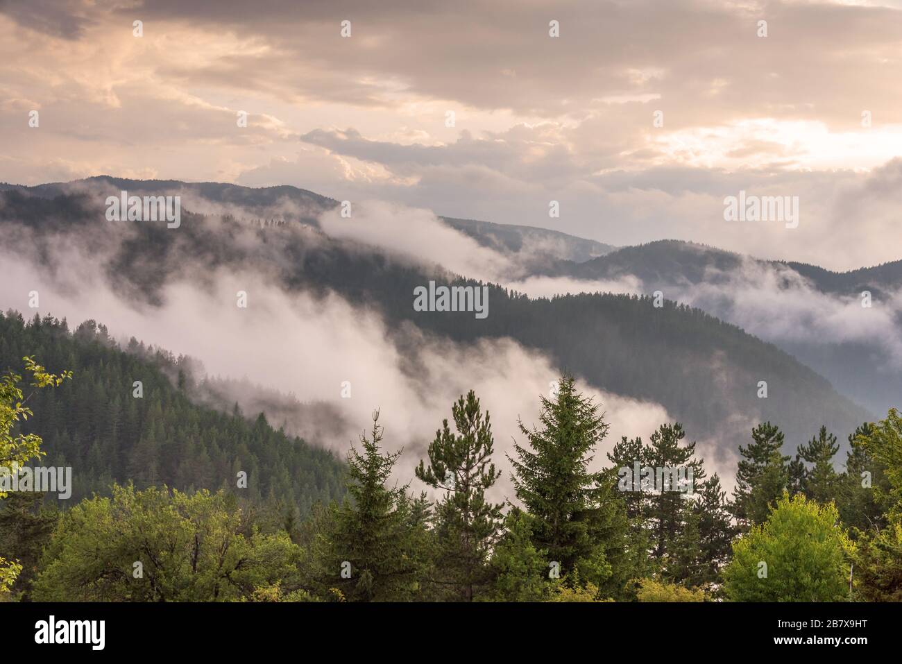 Amazing mountain landscape with colorful vivid sunset at fog Stock ...