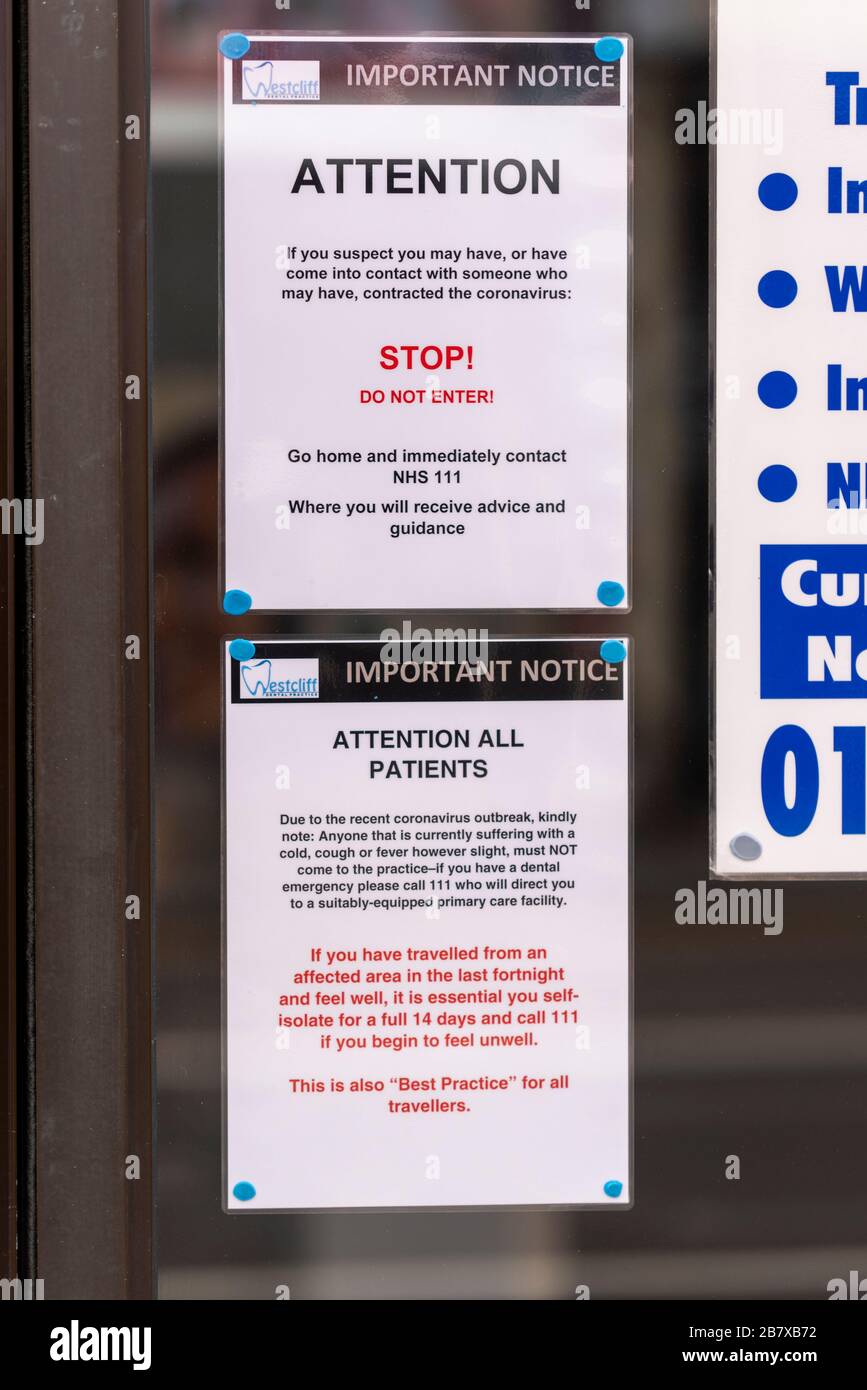 Westcliff Dental Practice with COVID-19 Coronavirus warning notice warning customers not to enter the office. Stop, do not enter sign on window Stock Photo