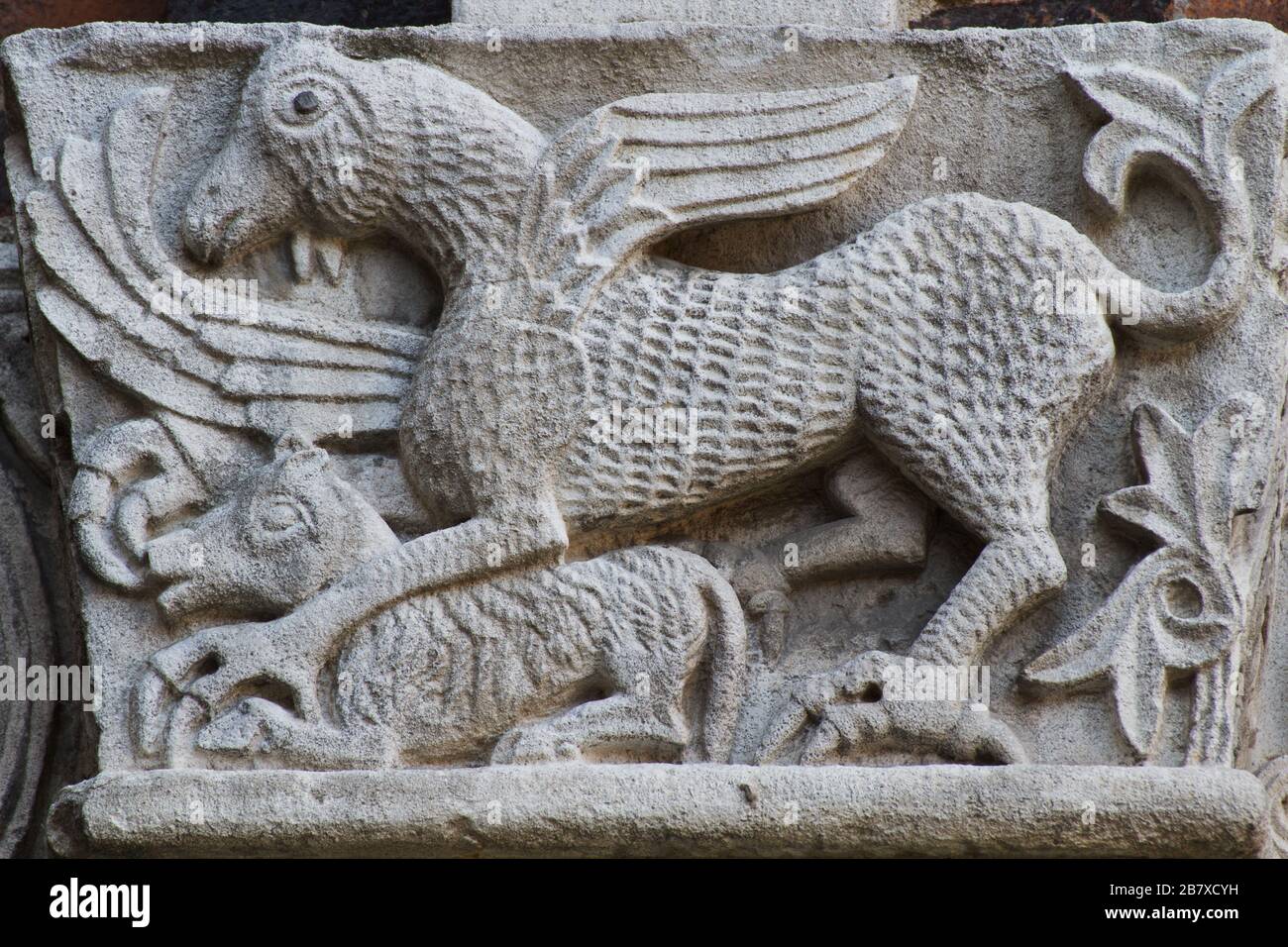 The Medieval Bestiary - Griffon and his pray - Fantastic Animals - Romanesque-style capital - Atrium of Ansperto - Basilica of Sant'Ambrogio - Milan Stock Photo