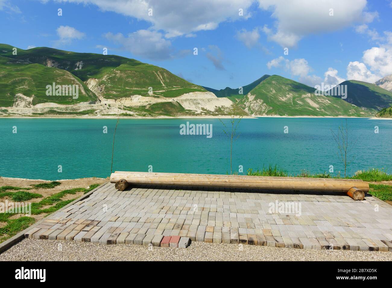 Improvised bench made of logs on the shore of the high-mountain lake Kezenoi Am in Vedensky district of the Chechen Republic, Russia Stock Photo