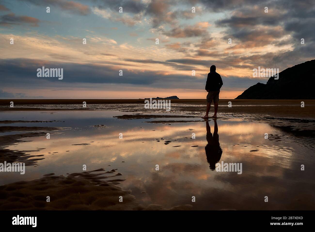 male silhouette in a landscape of a marsh at sunrise Stock Photo