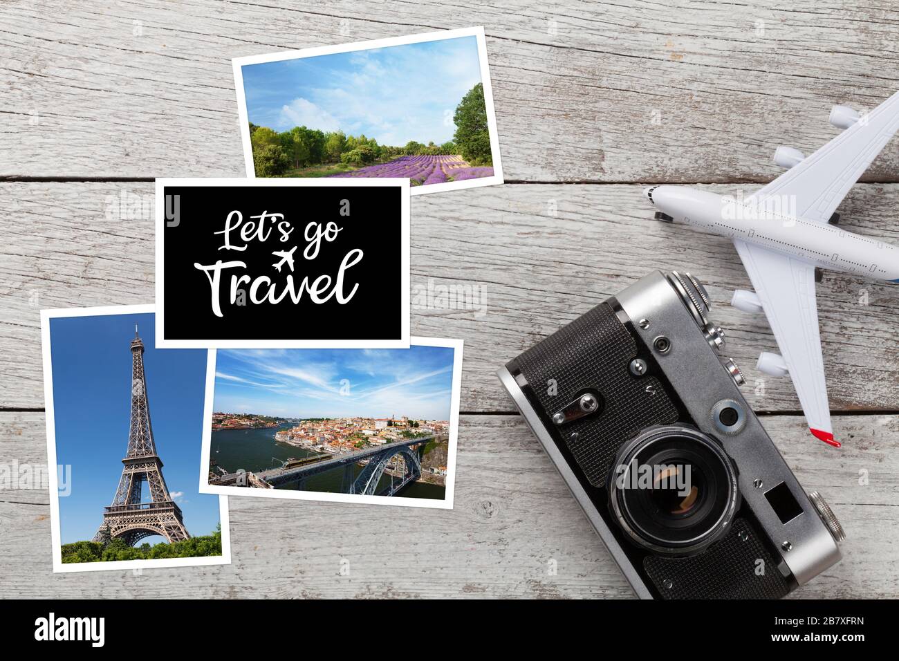 Travel concept with vacation photos, airplane toy and camera on wooden table. Top view flat lay with copy space Stock Photo