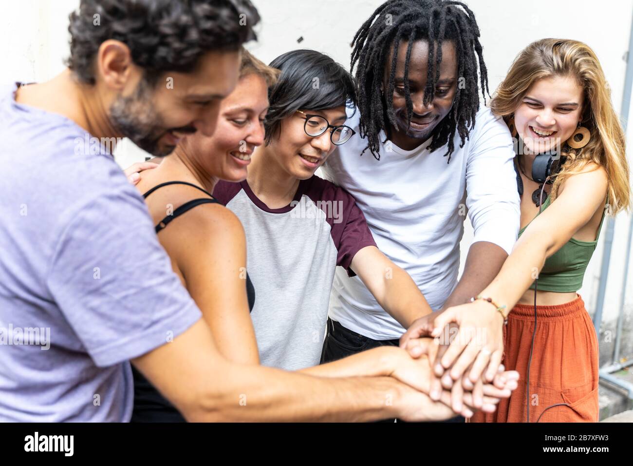 group of people from different ethnic groups putting their hand together in a team gesture Stock Photo