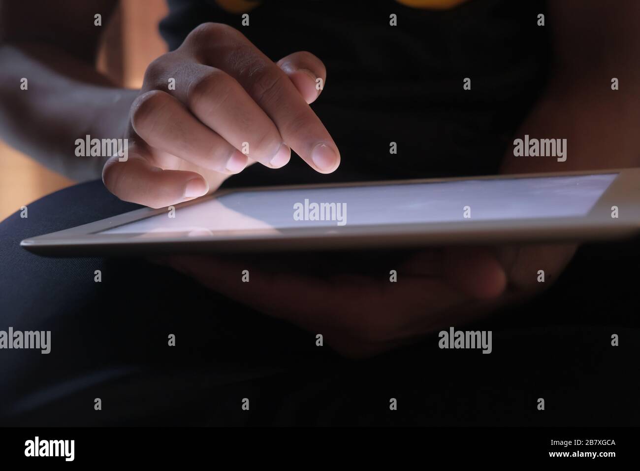 Close up of mans finger touching digital tablet screen Stock Photo