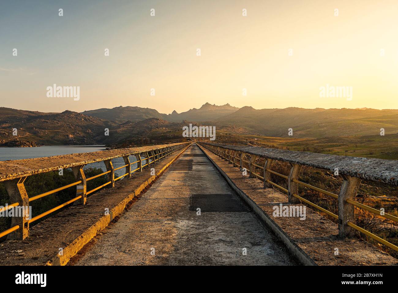 Crossing the dam Stock Photo Alamy