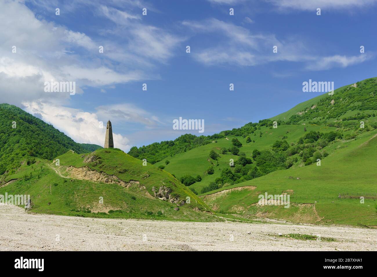 Karacolskiy watchtower of XIV century. on the territory of the settlement of the same name II-I thousand BC To the tower is a dirt road. The Chechen, Stock Photo