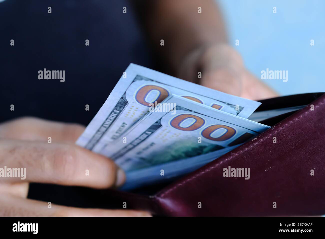 Businessman Person holding a wallet in the hands of take money out of pocket  Stock Photo