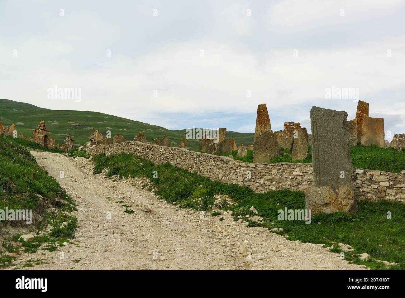Medieval necropolis 'City of the dead' in the settlement of Hoi. Tombstones are narrow, tall stones. Cloudy evening Stock Photo