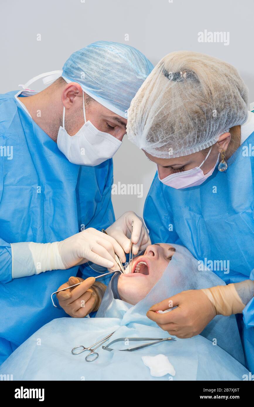 Dentists during surgery for implant placement Stock Photo Alamy