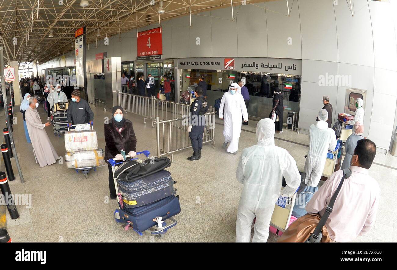 Farwaniya, Kuwait. 18th Mar, 2020. Egyptian passengers and workers in  protective suits are seen at Kuwait International Airport in Farwaniya  Governorate, Kuwait, on March 18, 2020. Kuwait deported 96 Egyptians to  their
