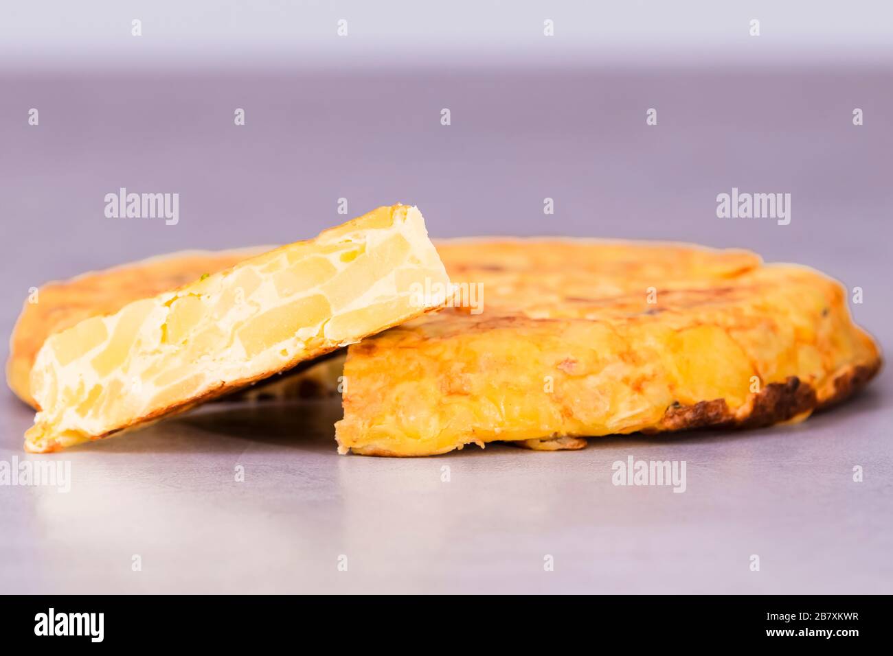 Delicious spanish omelet with a slice taken out Stock Photo