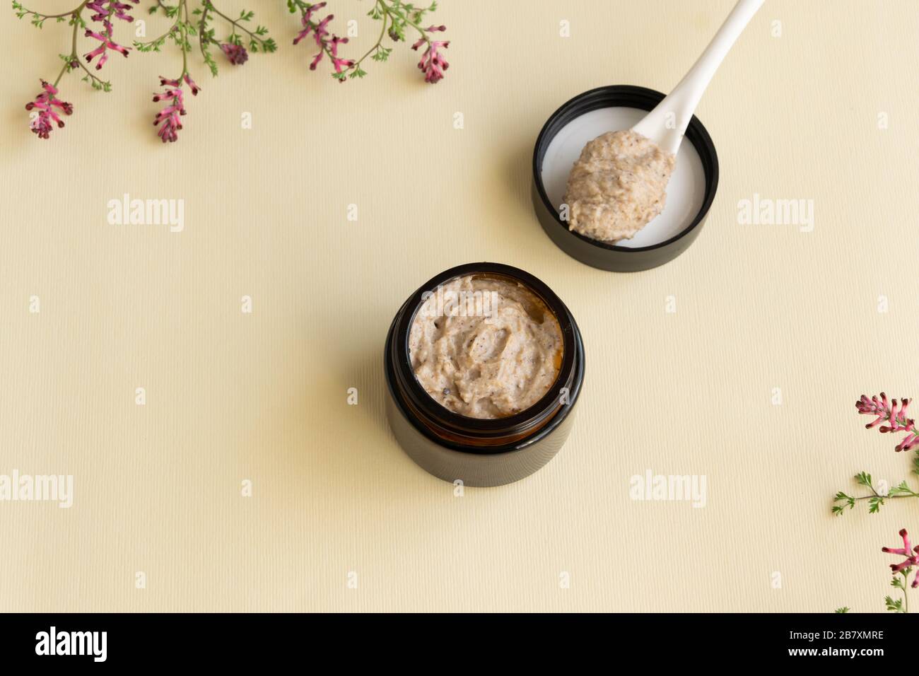 Hygiene bath product. Body, face scrub with wild flowers. Wellness therapy regeneration Stock Photo