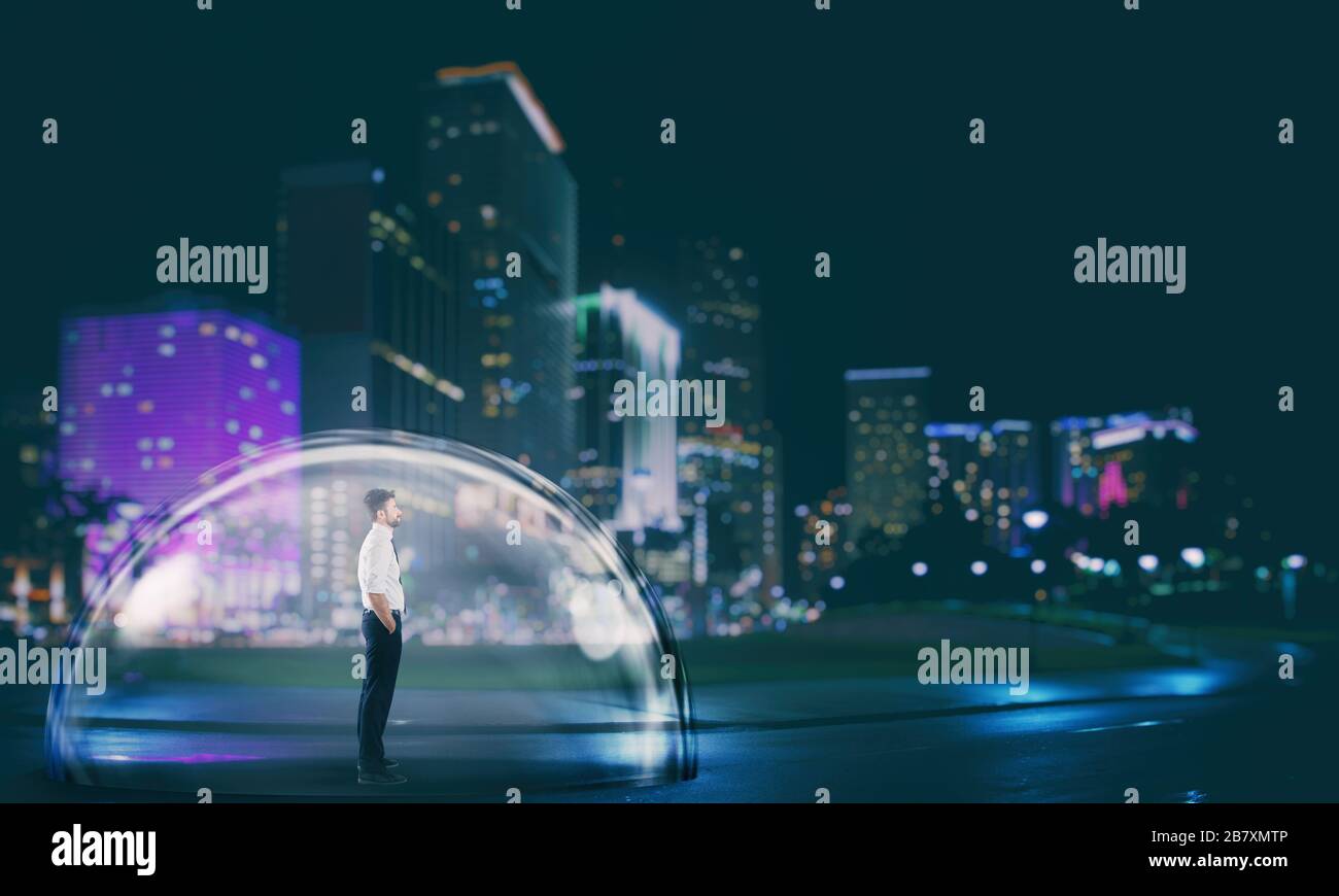 Businessman safely inside a shield dome in the city at night. Protection and safety concept Stock Photo