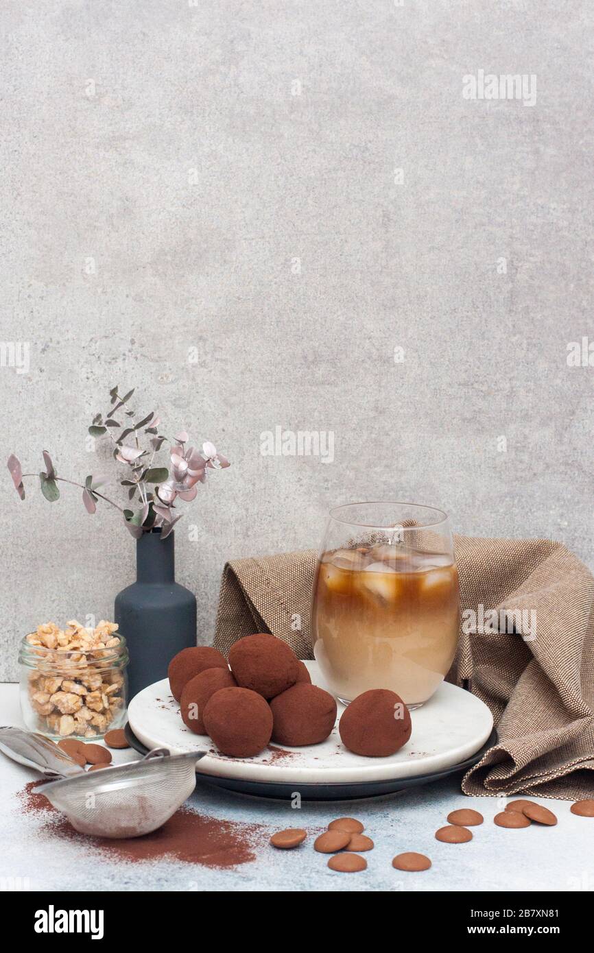 Cold coffee liqueur with chocolate truffles, rolled in cocoa powder on grey background Stock Photo