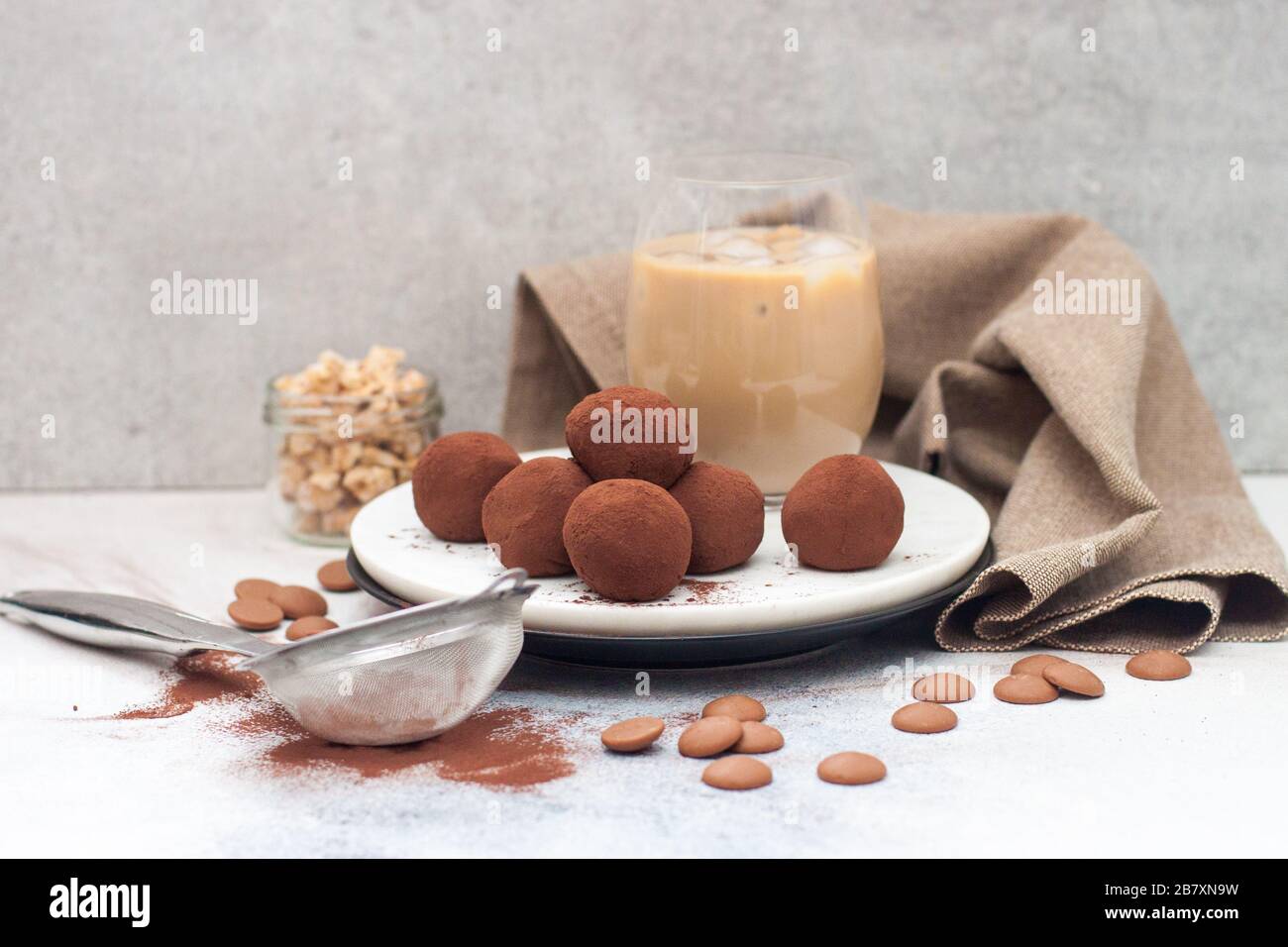Cold coffee liqueur with chocolate truffles, rolled in cocoa powder on grey background Stock Photo