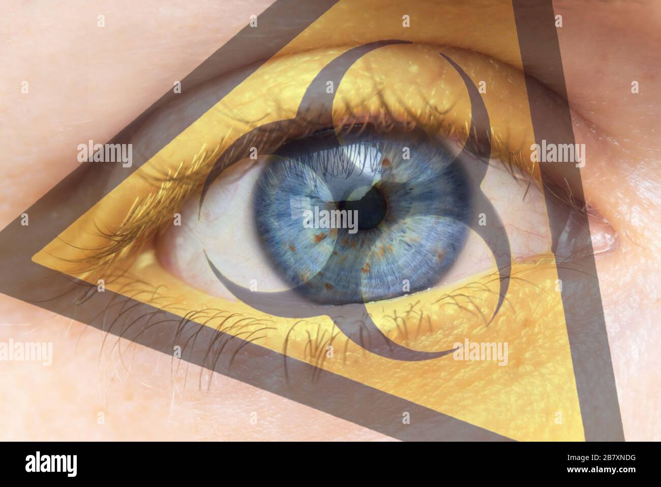 Coronavirus global Pandemic outbreak and quarantine concept. Creative composite of of woman eye with biohazard symbol .  Stock Photo