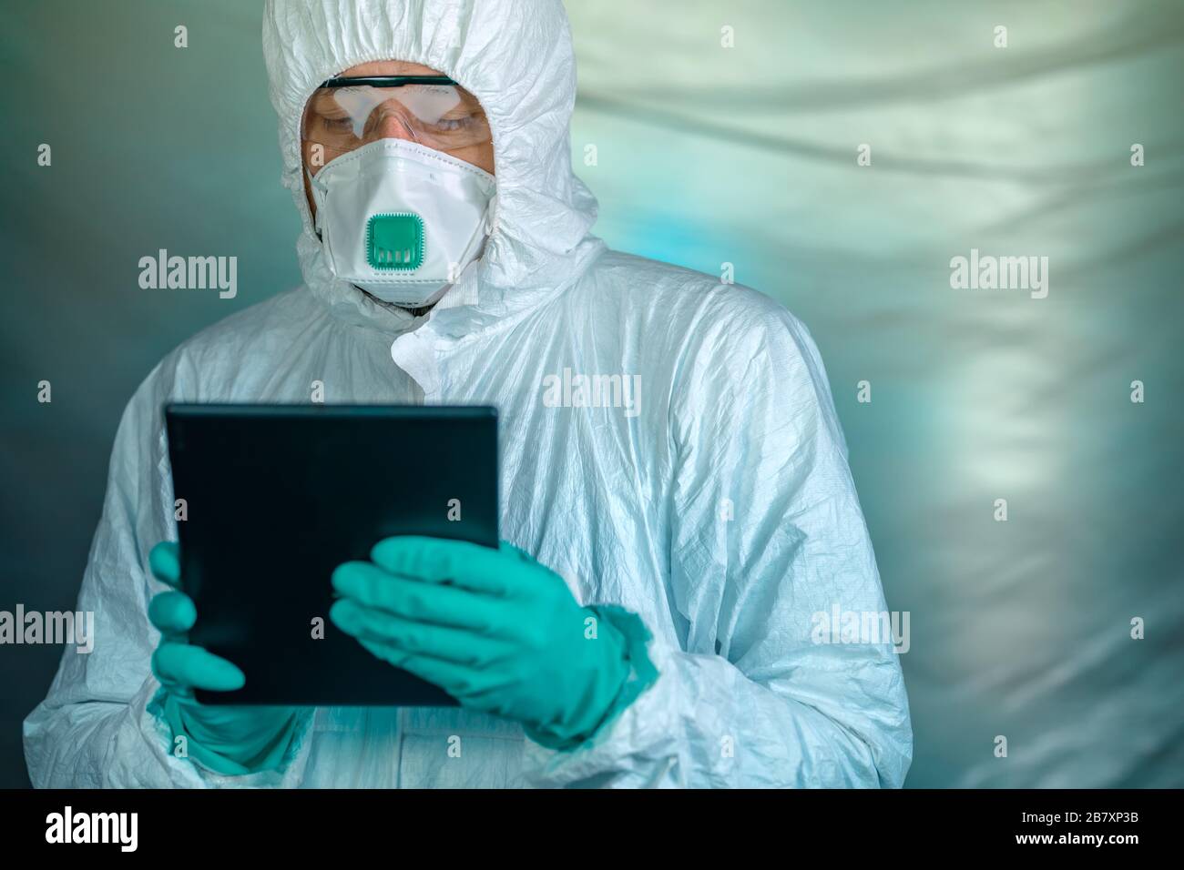 Epidemiologist using digital tablet computer in Wuhan coronavirus quarantine, conceptual image with selective focus Stock Photo