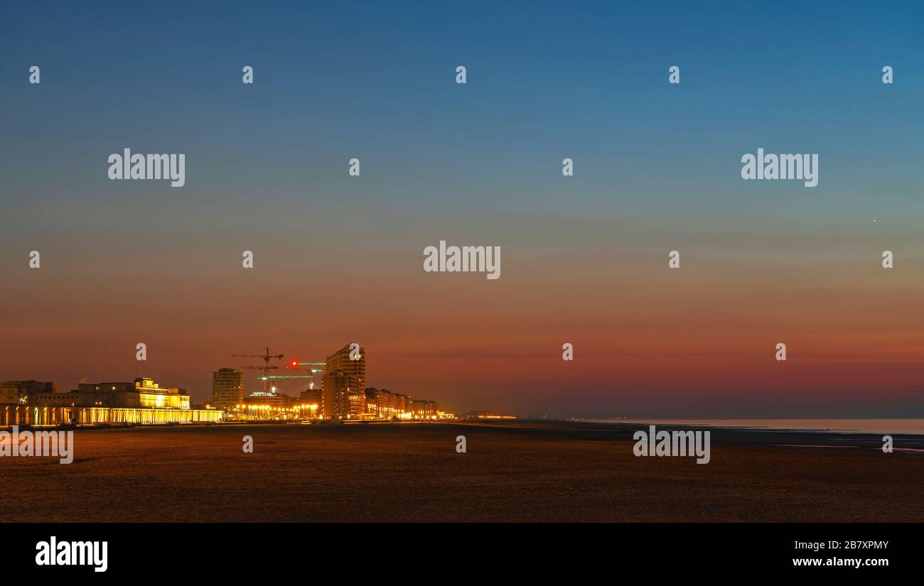 Panorama of Oostende (Ostend) city at sunset with its waterfront promenade, beach and North Sea, Belgium. Stock Photo