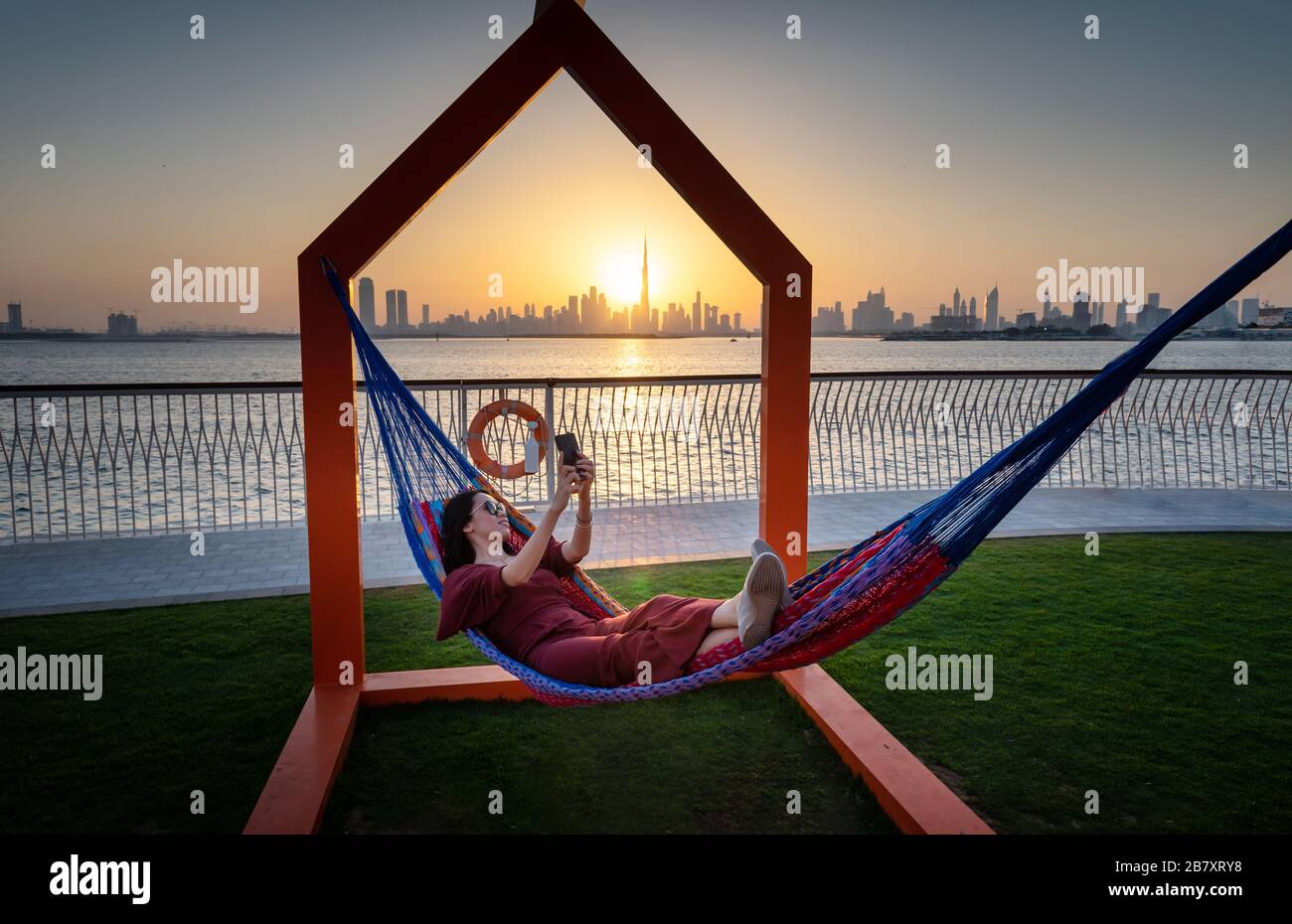 Woman enjoying beautiful sunset view of Dubai from the creek harbor Stock Photo
