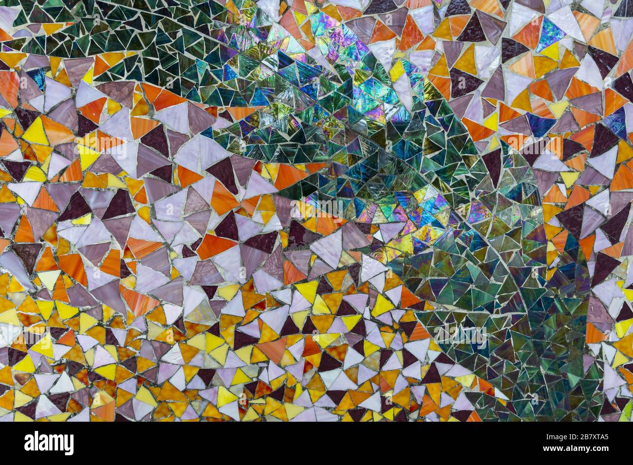 Close up view of colorful mosaic on building wall. Street arts concept. Beautiful backgrounds. Stock Photo