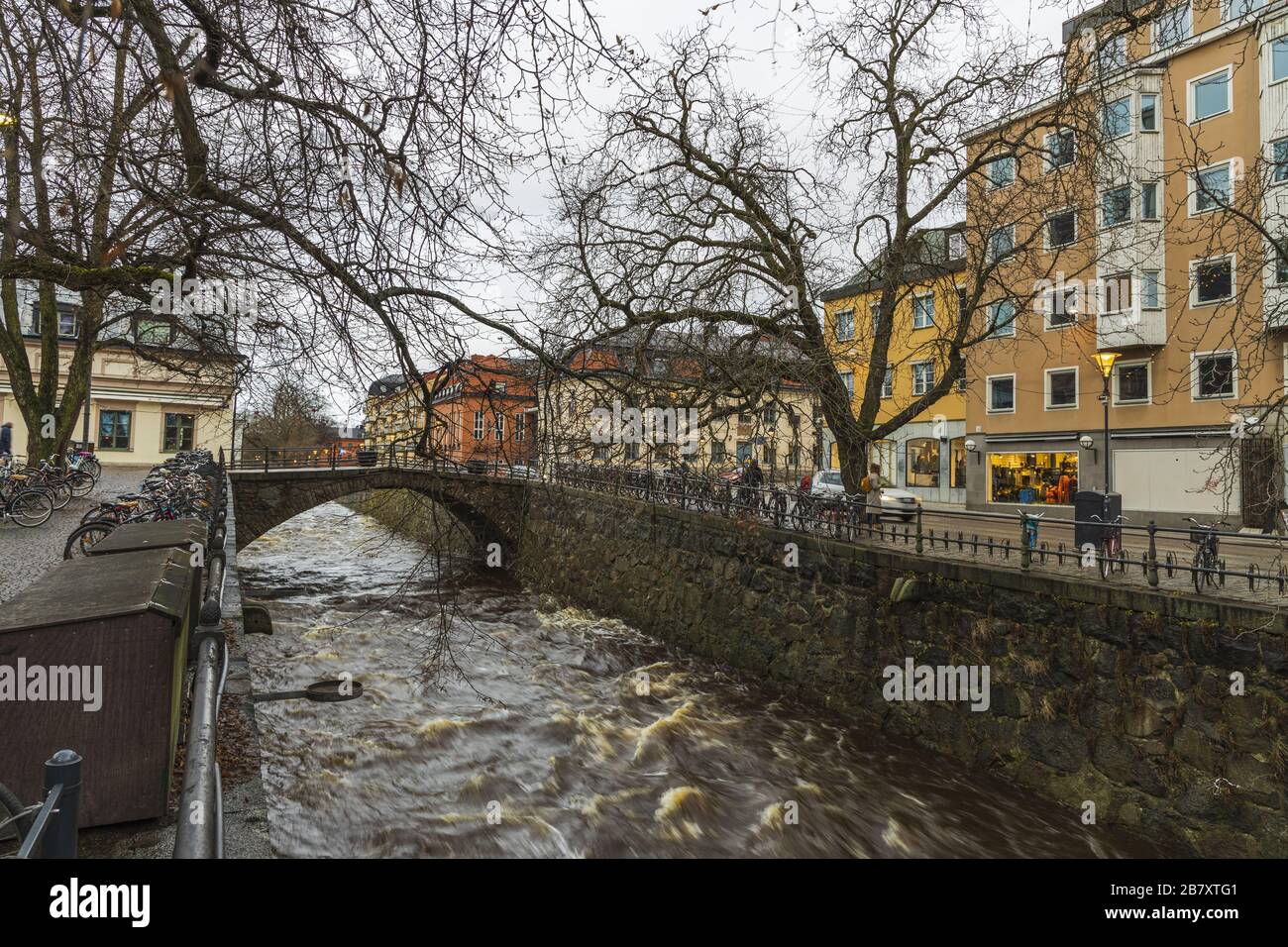 Gorgeous view on  street near river on background. Gorgeous sky with thunderclouds on a winter day.  Tourism, travel concept. Europe, Sweden, Uppsala. Stock Photo