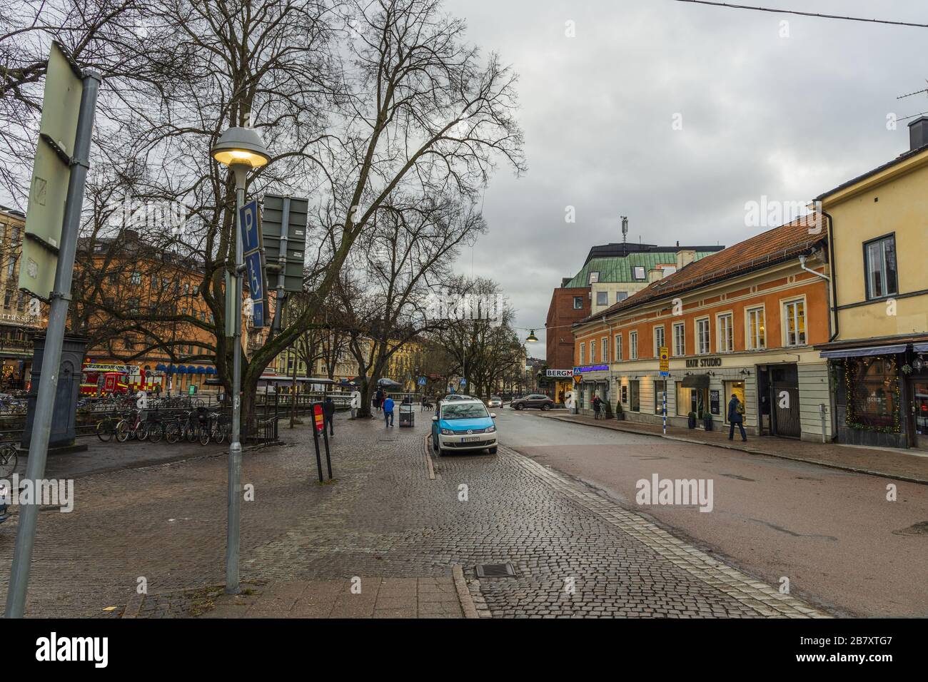 View of street of Uppsala, Sweden. Sky with thunderclouds in winter day.Red buildings on sky background. Tourism, travel concept. Europe, Sweden, Upps Stock Photo
