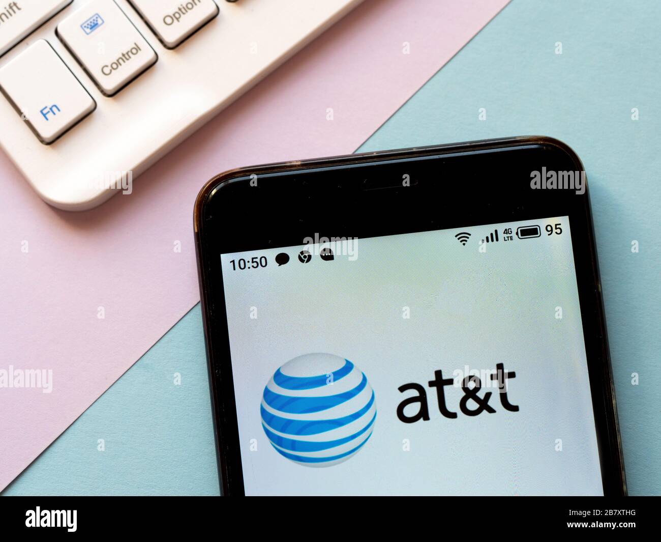 In this photo illustration an AT&T logo is seen displayed on a ...