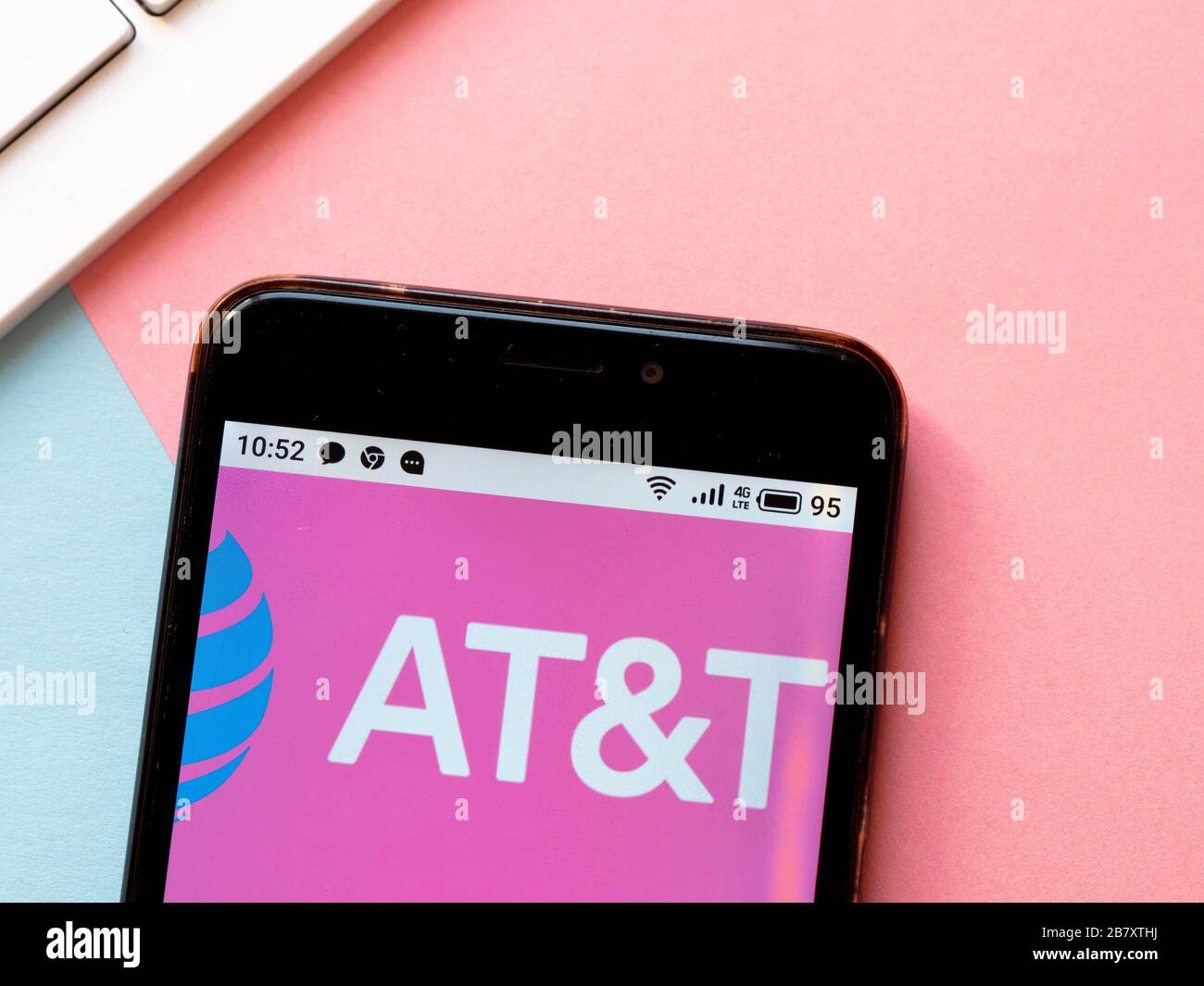 In this photo illustration an AT&T logo is seen displayed on a ...
