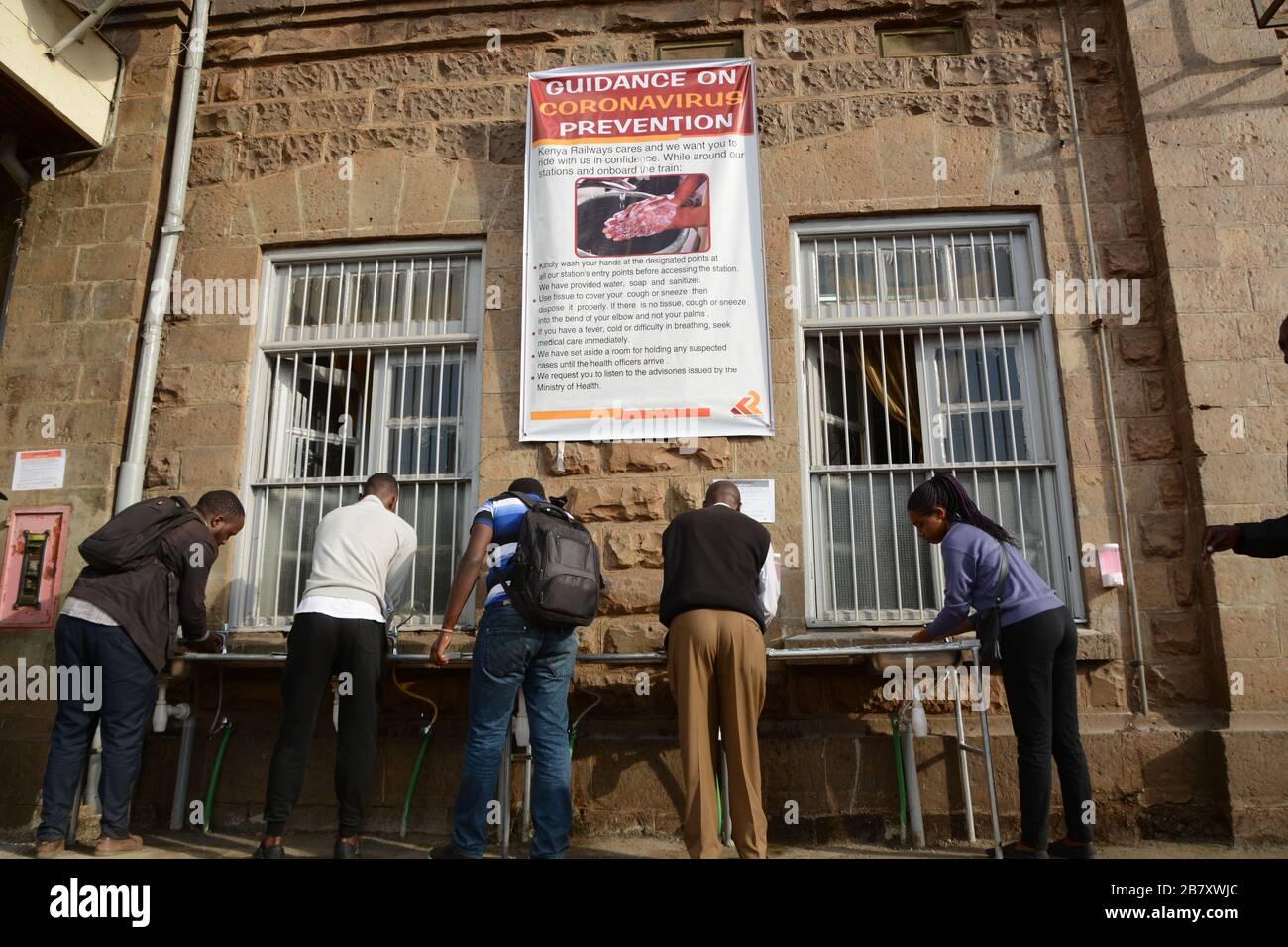 Commuters outside Nairobi Railway Station wash their hands before
