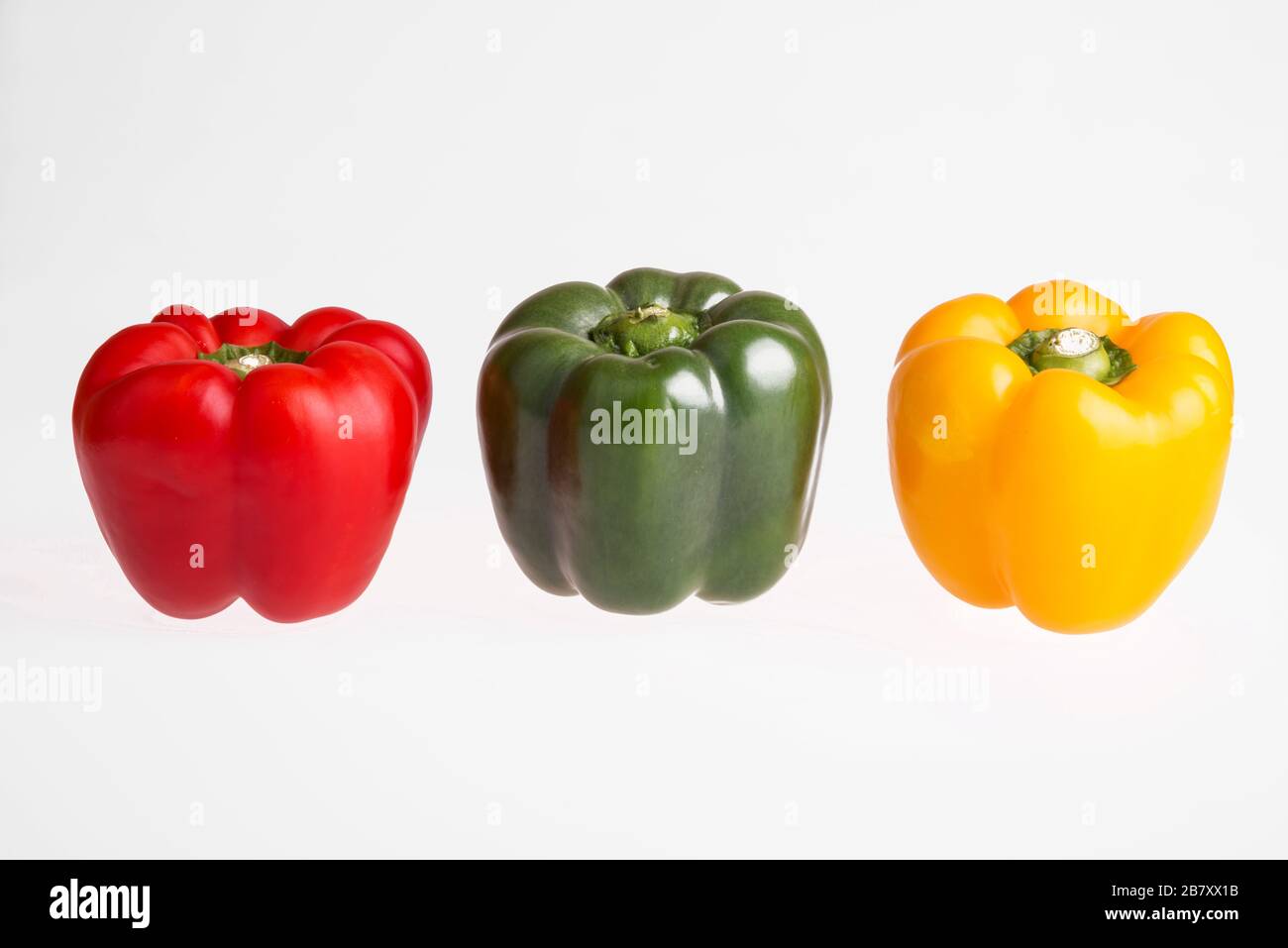 Red, green and yellow pepper on a white background Stock Photo - Alamy