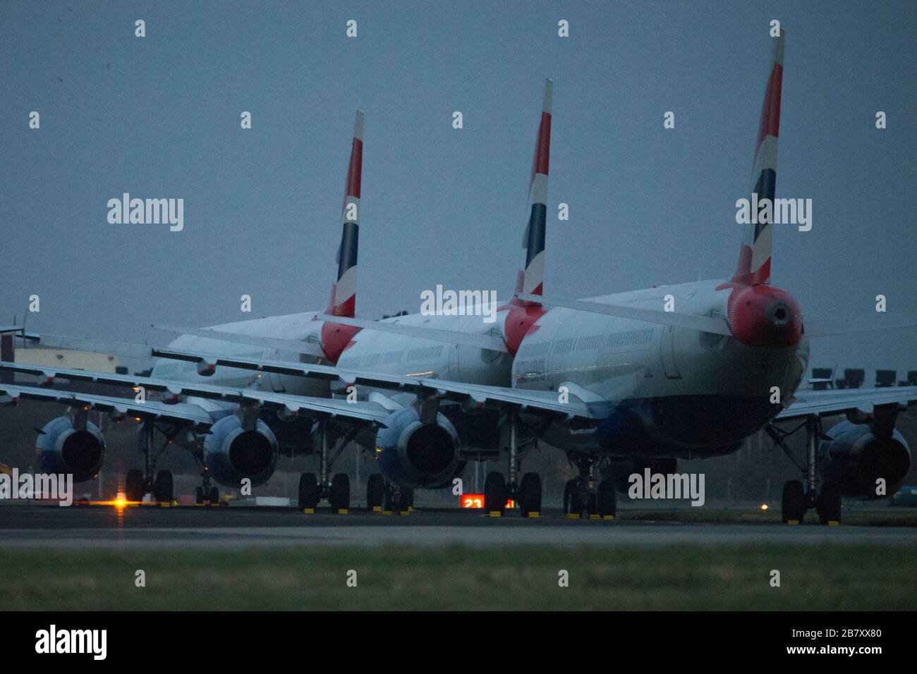 Glasgow, UK. 18th Mar, 2020. Pictured: British airways Airbus A321 Jets stand grounded on the tarmac of Glasgow International Airport, due to British Airways and other airlines deciding to cancel a massive amount of flights to stop the spread of the Coronavirus. Also a number of countries are also not accepting any UK flights which further compounds the economic downturn the UK aviation is presently experiencing. Credit: Colin Fisher/Alamy Live News Stock Photo
