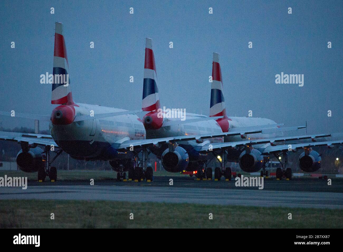 Glasgow, UK. 18th Mar, 2020. Pictured: British airways Airbus A321 Jets stand grounded on the tarmac of Glasgow International Airport, due to British Airways and other airlines deciding to cancel a massive amount of flights to stop the spread of the Coronavirus. Also a number of countries are also not accepting any UK flights which further compounds the economic downturn the UK aviation is presently experiencing. Credit: Colin Fisher/Alamy Live News Stock Photo