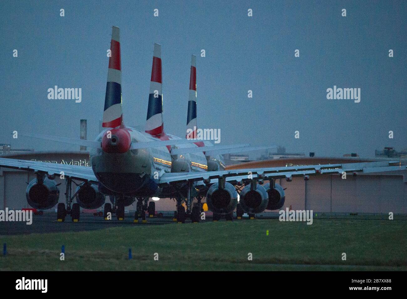 Glasgow, UK. 18th Mar, 2020. Pictured: British airways Airbus A321 Jets stand grounded on the tarmac of Glasgow International Airport, due to British Airways and other airlines deciding to cancel a massive amount of flights to stop the spread of the Coronavirus. Also a number of countries are also not accepting any UK flights which further compounds the economic downturn the UK aviation is presently experiencing. Credit: Colin Fisher/Alamy Live News Stock Photo