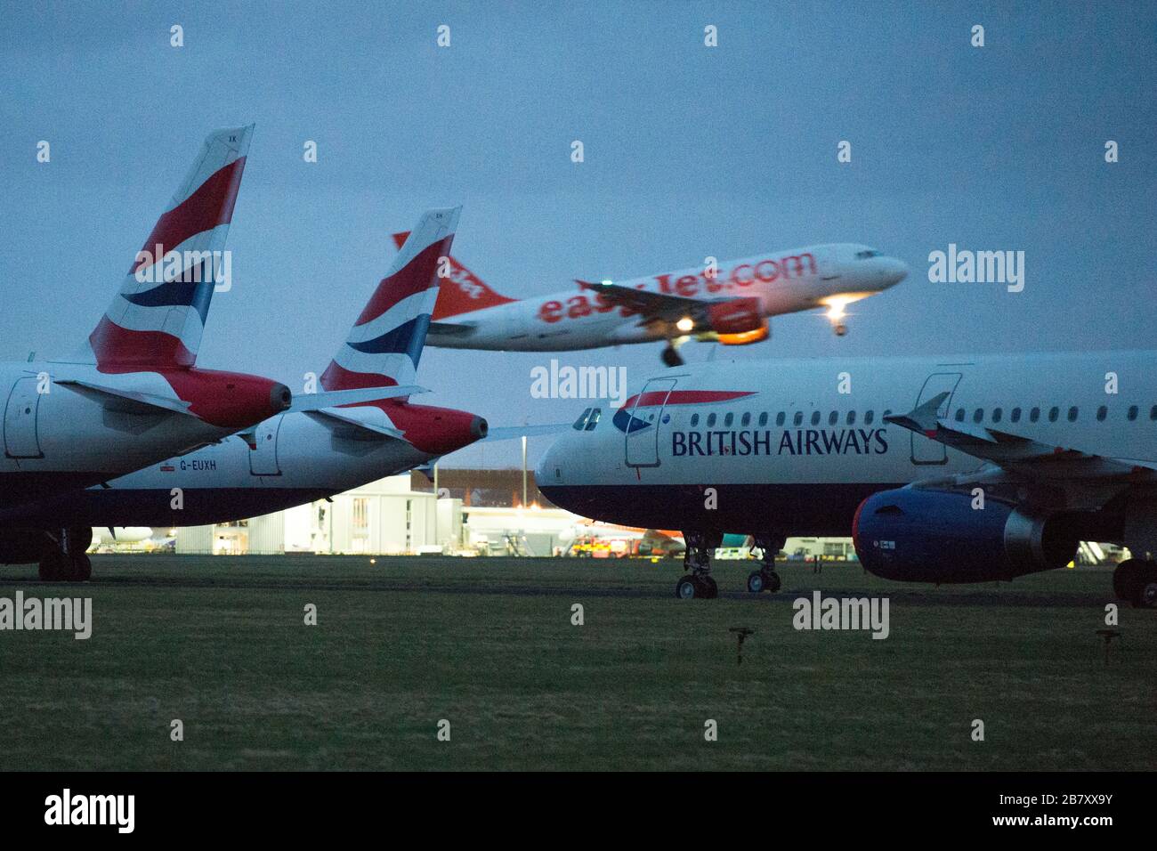 Glasgow, UK. 18th Mar, 2020. Pictured: British airways Airbus A321 Jets stand grounded on the tarmac of Glasgow International Airport, due to British Airways and other airlines deciding to cancel a massive amount of flights to stop the spread of the Coronavirus. Also a number of countries are also not accepting any UK flights which further compounds the economic downturn the UK aviation is presently experiencing. Credit: Colin Fisher/Alamy Live News Stock Photo