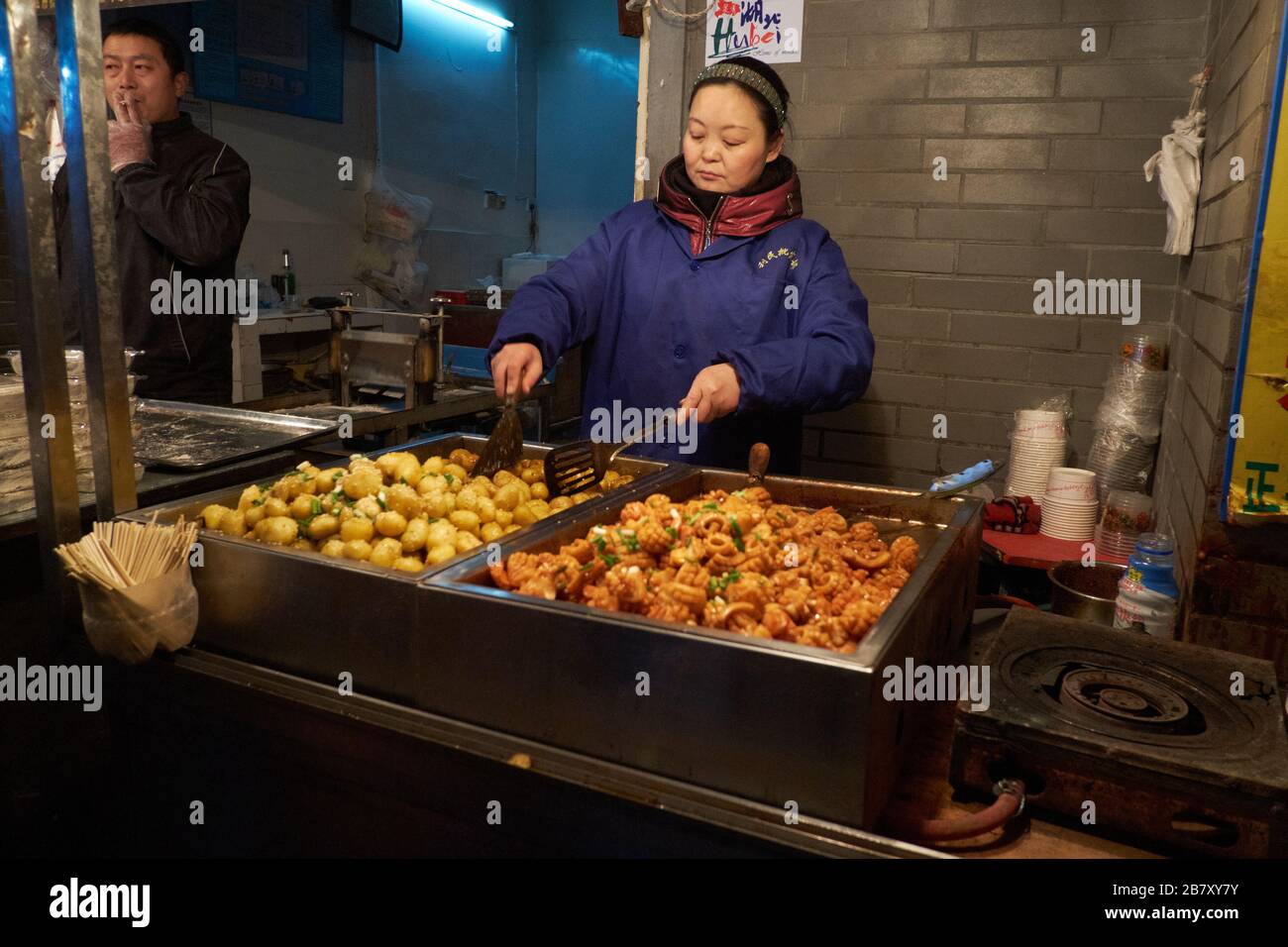 Wuhan, China in Hubei Province, shot in 2013, showing stallholders preparing and serving cooked food. Stock Photo