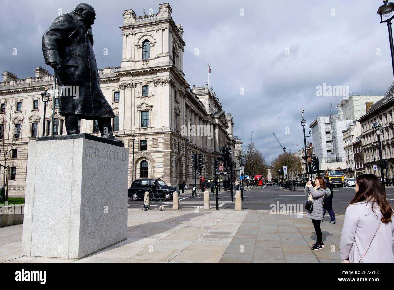 London, UK 18 March 2020. A statue of former British Prime Minister, Winston Churchill overlooks an unusually deserted Parliament Square. Stock Photo
