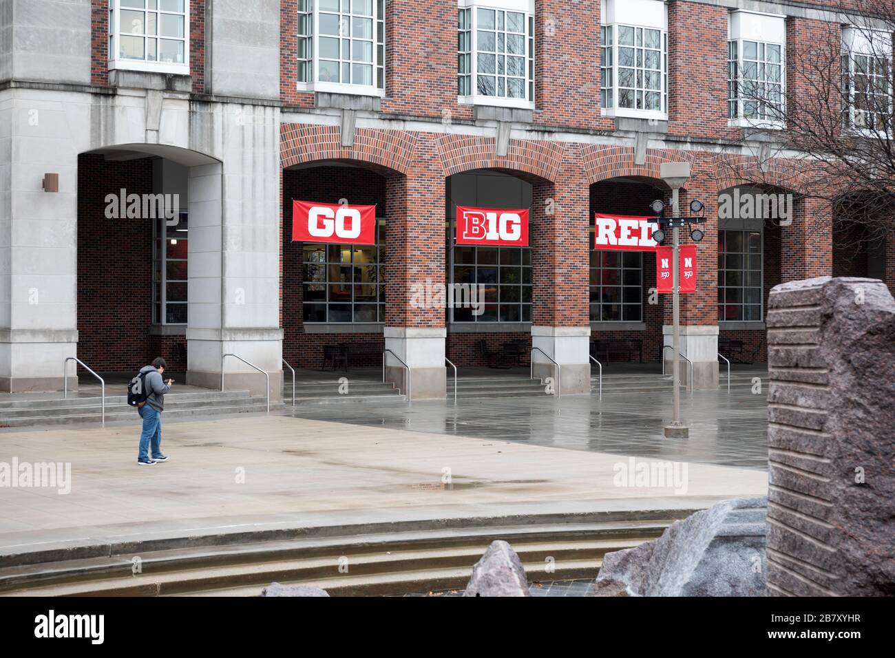 A lone person walking across the nearly deserted plaza at the UNL student union plaza during the 2020 COVID-19 shutdown. Stock Photo