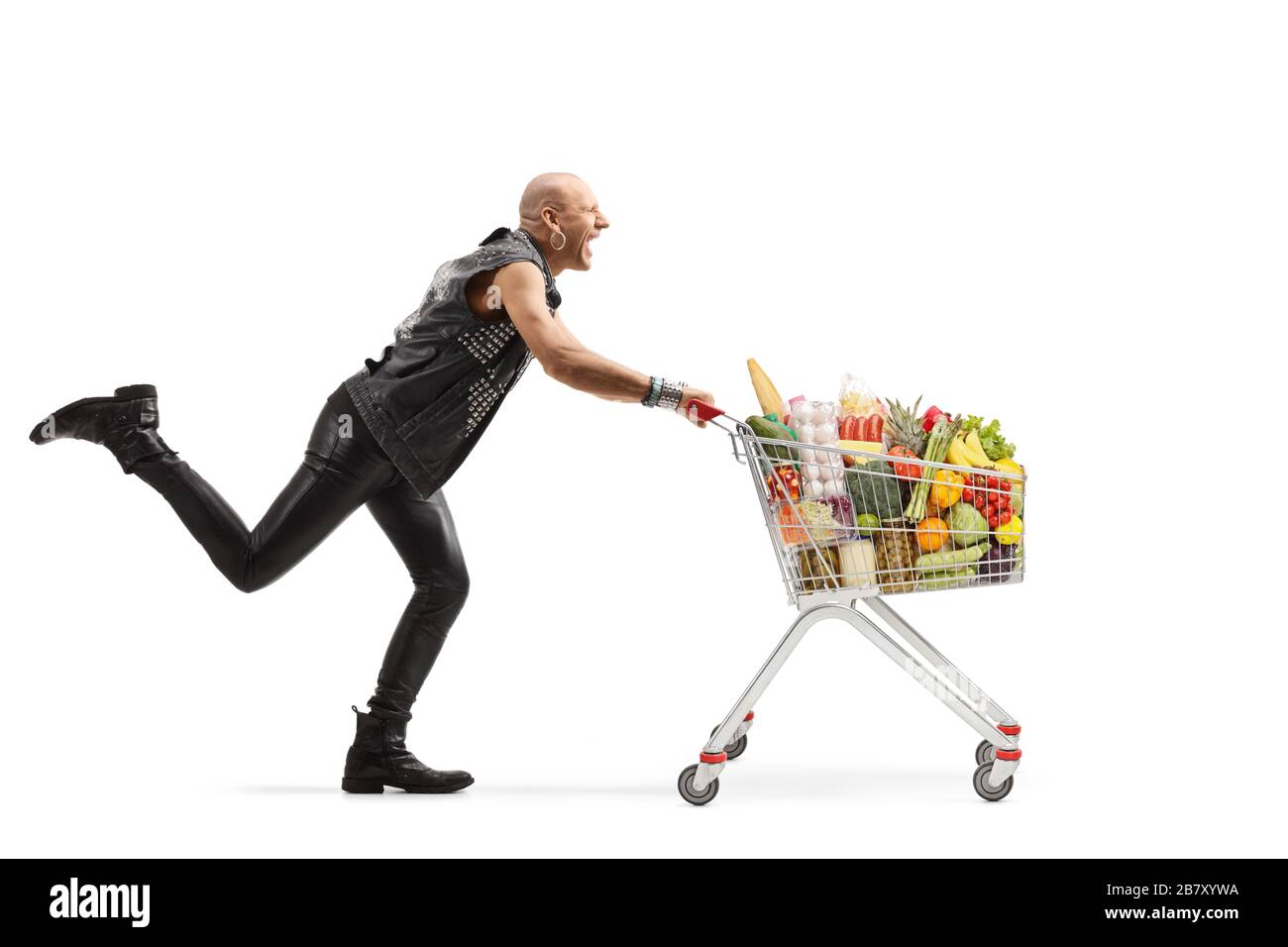 Full length profile shot of a crazy punk running and pushing a shopping cart  full of food isolated on white background Stock Photo - Alamy