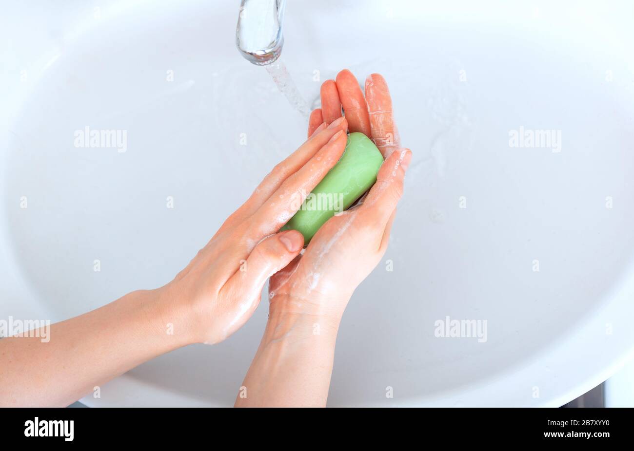 Woman washing hands with antibacterial green soap and water. Hygiene ...